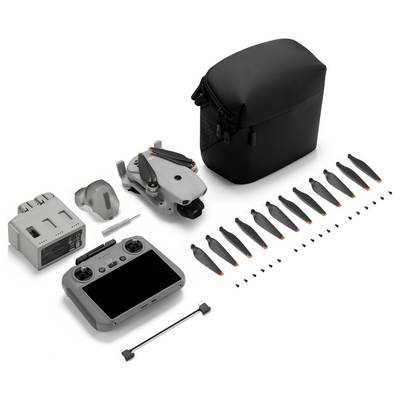 Kit de drone avec étui de transport, télécommande, batterie, chargeur, hélices de rechange et petits outils sur un fond blanc