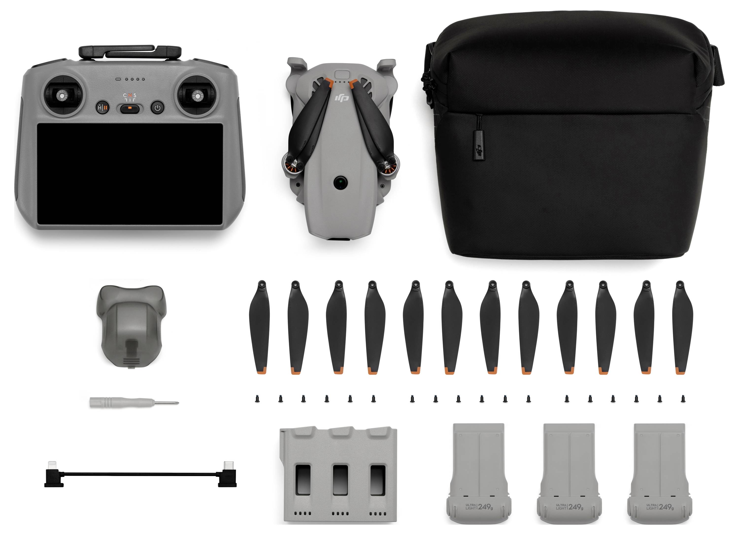 Kit de contrôleur de drone présenté avec l'avant et l'arrière du contrôleur, un étui de transport, plusieurs hélices de rechange, un tournevis, un concentrateur de charge, un câble de charge et trois batteries.