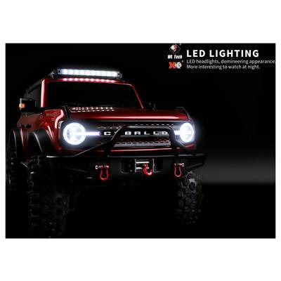 Camion tout-terrain rouge avec projecteurs LED brillants et barre lumineuse de toit, promouvant l'« ÉCLAIRAGE LED » pour la conduite de nuit.