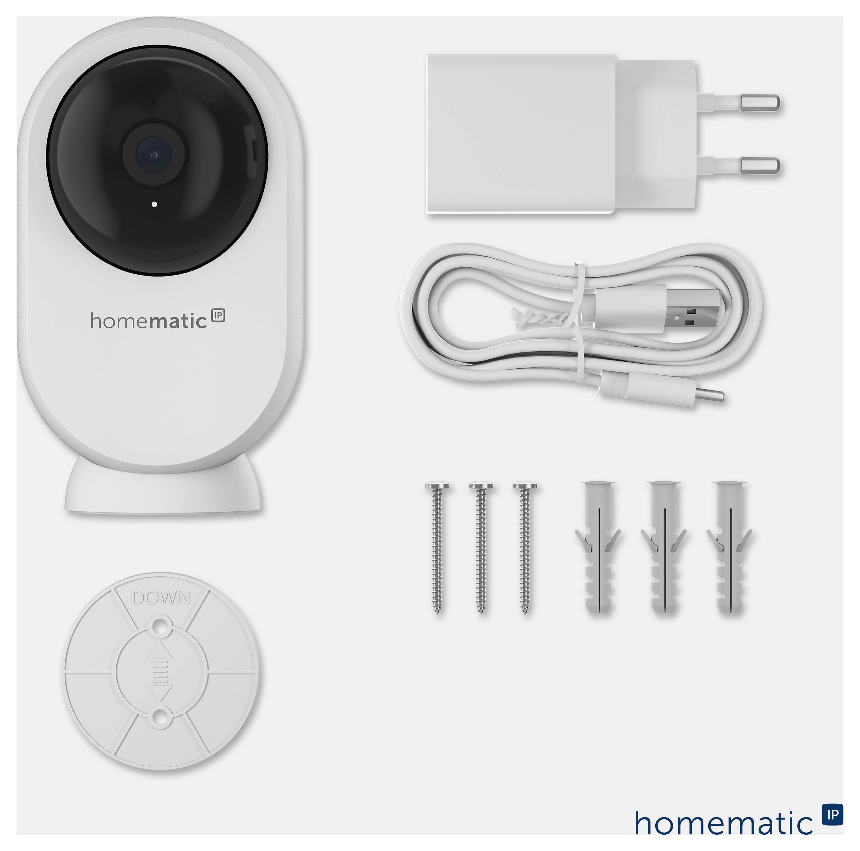 Kit de caméra de sécurité intérieure Homematic avec caméra, adaptateur secteur, câble USB, vis de montage et chevilles murales, plus plaque de montage ronde.