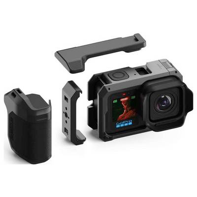 Vue éclatée d'une caméra d'action de style GoPro avec batterie latérale amovible, support de cadre, couvercle supérieur et objectif/écran frontal présentés séparément.