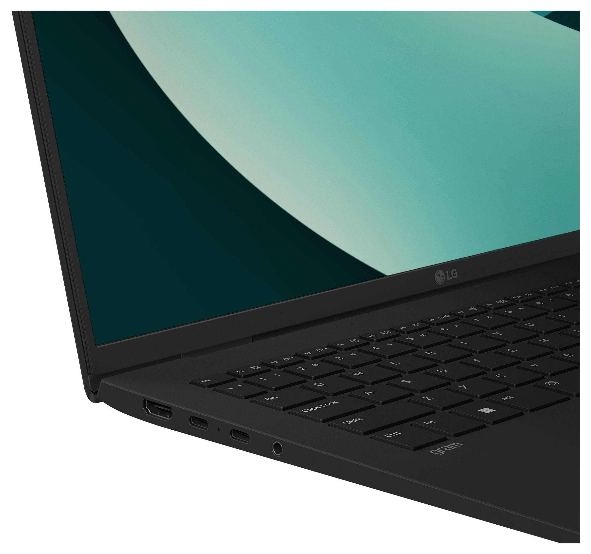 Gros plan d'un ordinateur portable LG noir montrant le coin de l'écran, la charnière, le clavier et les ports latéraux avec un affichage bleu-vert.