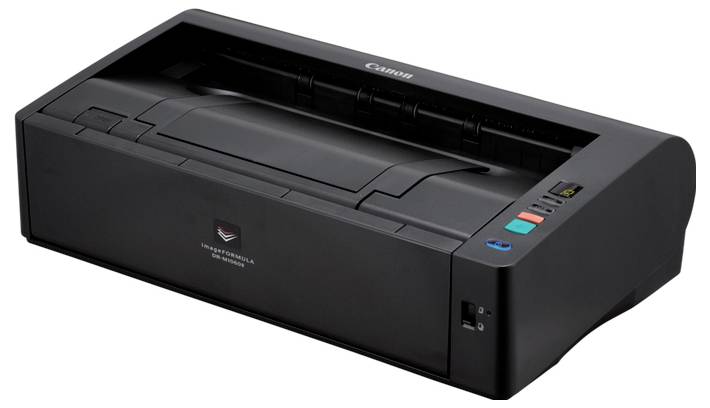 Imprimante de bureau Canon noire avec bac d'alimentation papier et boutons de commande supérieurs, présentée en vue trois-quarts sur fond blanc