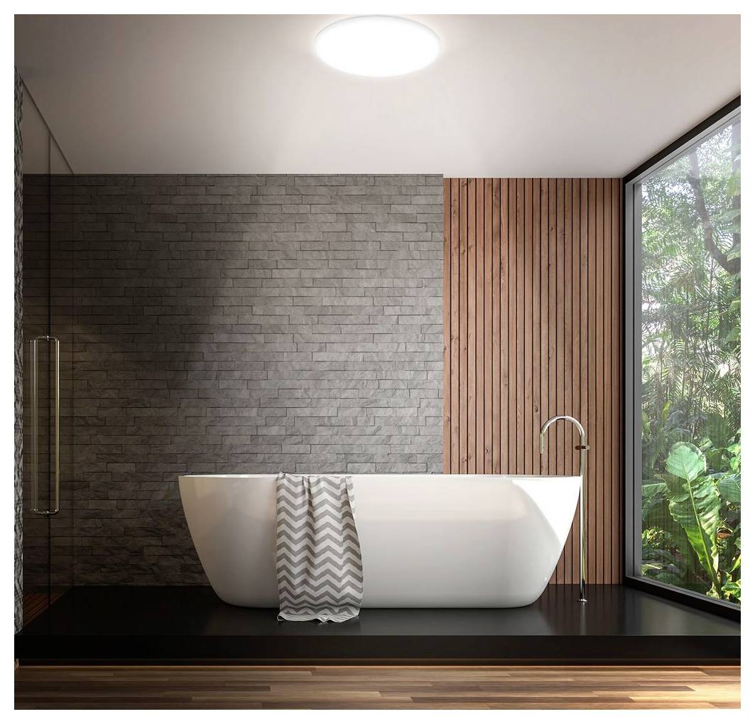 Meuble-lavabo de salle de bain moderne avec deux miroirs ronds au-dessus de vasques blanches en forme de vasque, situé contre un mur carrelé clair sous un plafonnier.