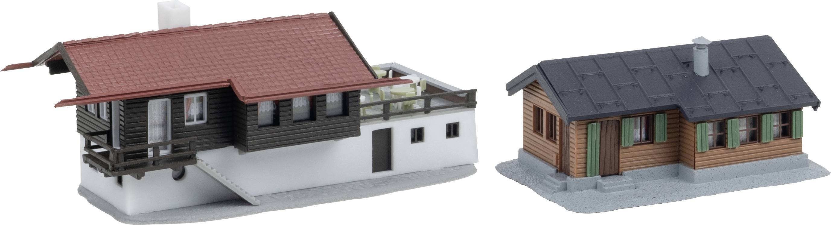 Deux petits bâtiments miniatures : une plus grande maison avec toit rouge et base blanche et balcon sur la gauche, et une plus petite cabane en bois avec toit foncé sur la droite.
