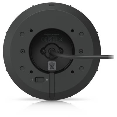 Vue arrière d'un appareil noir rond avec un câble d'alimentation branché au centre et de petits ports et étiquettes sur la base.