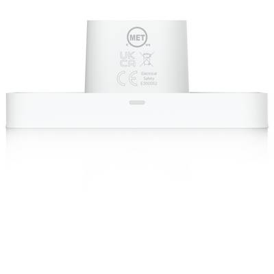 Dispositif électrique cylindrique blanc ou adaptateur montré en vue de face, avec des marques de certification et un petit indicateur sur un fond blanc uni.