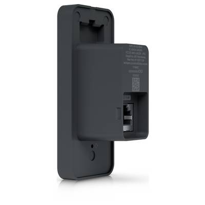 Appareil électrique noir fixé au mur avec une ouverture frontale et une fente de connecteur, probablement une unité de recharge ou une prise de courant.