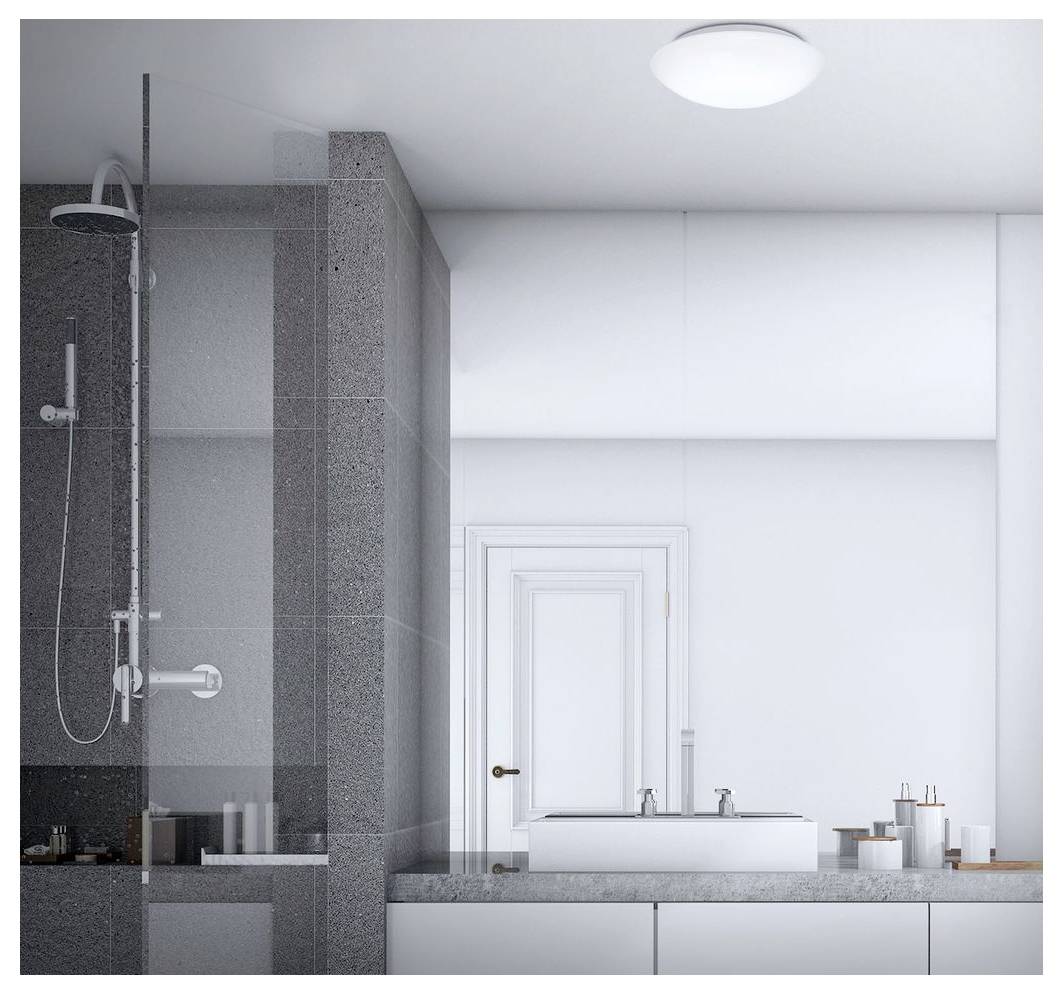 Salle de bain moderne avec une douche vitrée sur la gauche et un meuble double vasque avec miroir sur la droite, aux tons gris et blanc.