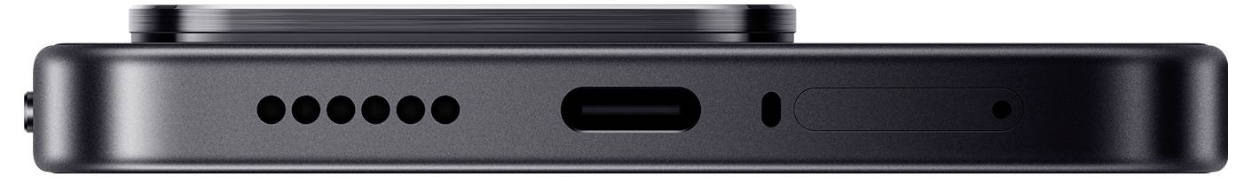 Vue latérale d'un smartphone noir montrant le bord inférieur avec les trous du haut-parleur, le port USB-C, le microphone et les lignes d'antenne.