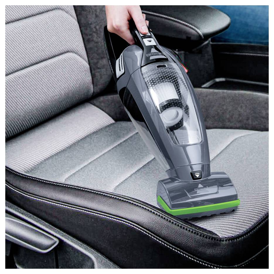 Aspirateur portatif nettoyant un rembourrage de siège automobile