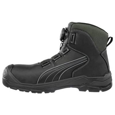 Botte de travail montante noire avec semelle robuste, lacets latéraux et col rembourré vert présentée de profil sur fond blanc.