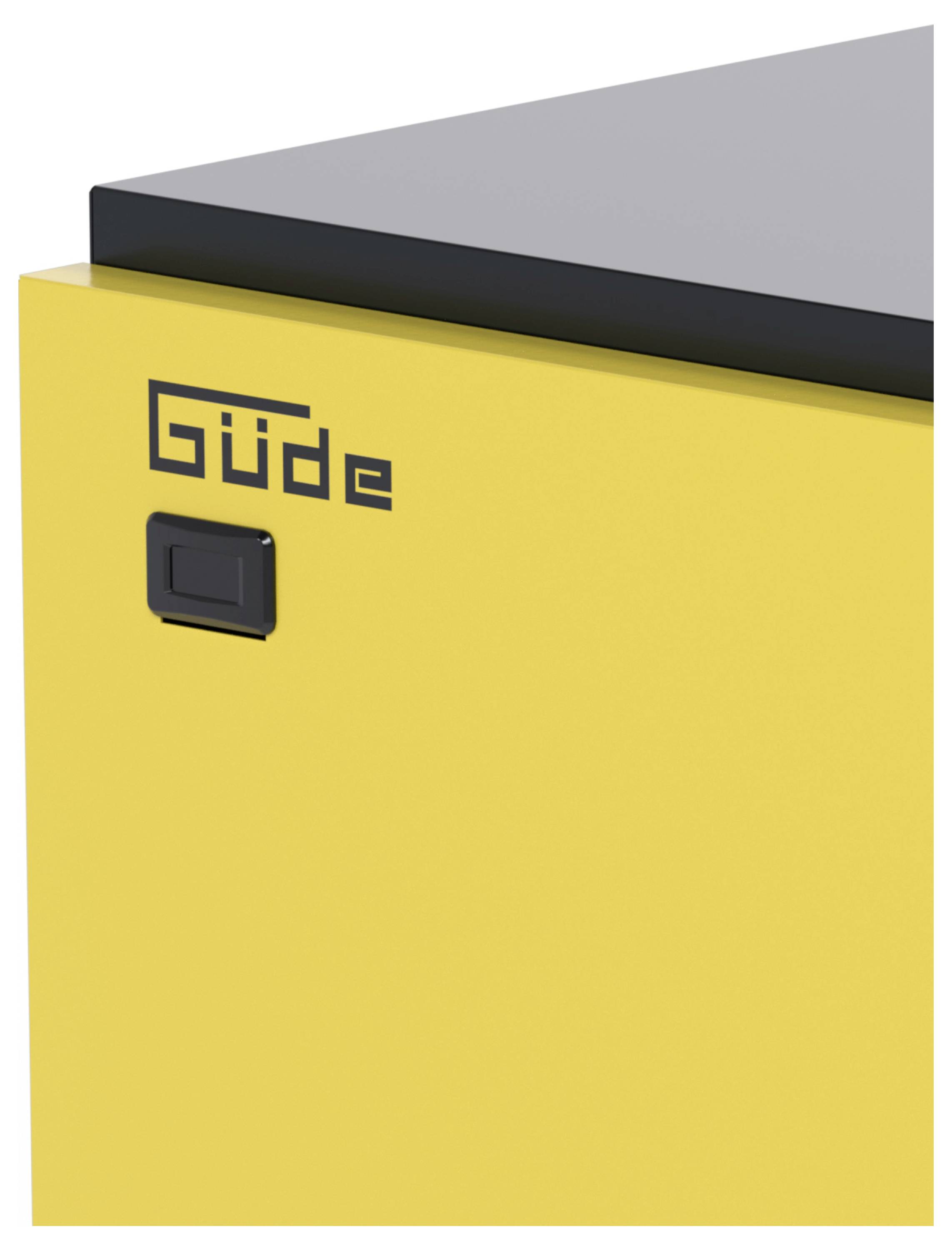 Gros plan d'un boîtier de machine Güde jaune avec un interrupteur noir et un panneau de couverture supérieur.