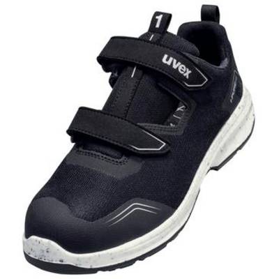 Chaussure de sécurité athlétique Uvex noire avec deux bandes Velcro et semelle blanche, présentée sur un fond uni.