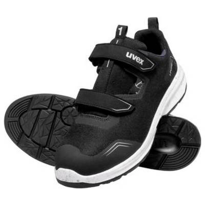 Chaussure de travail athlétique Uvex noire présentée de côté et vue de la semelle, avec une bande de roulement épaisse et des sangles Velcro sur un fond blanc.