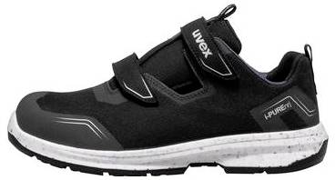 Chaussure de sport basse noire avec semelle blanche pointillée et bandes velcro, présentée en vue latérale sur un fond uni.