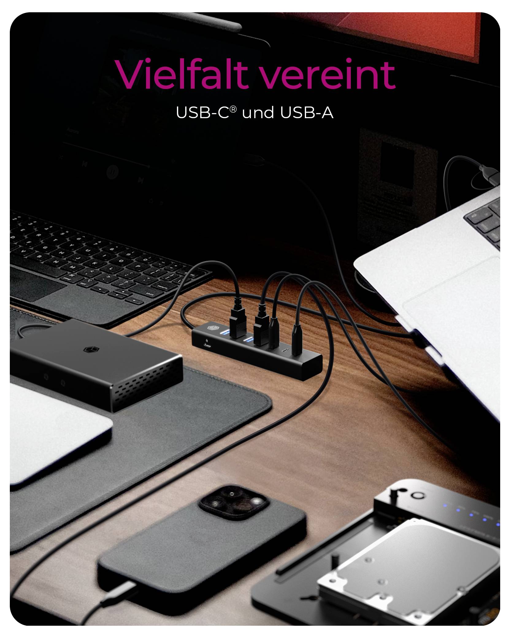 Configuration de bureau affichant un hub USB-C et USB-A chargeant plusieurs appareils et connectant un ordinateur portable, avec le texte « Vielfalt vereint » et « USB-C® et USB-A ».