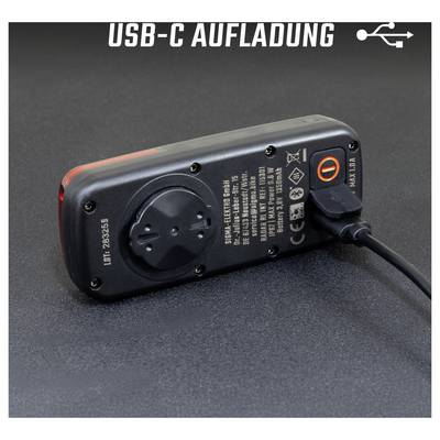 Chargeur USB-C avec câble intégré ; interrupteur orange luminescent indique un processus de charge actif.