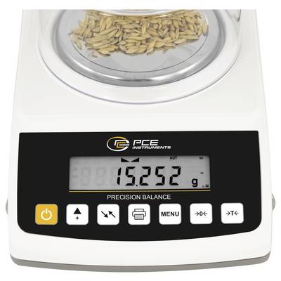 Balance de précision avec échantillon de grain sur le plateau de pesage, affichage numérique indiquant 15,252 g et boutons de commande sur le panneau frontal.