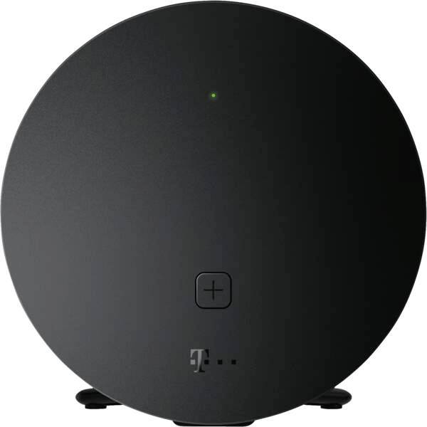 Routeur ou modem T-Mobile circulaire noir sur un fond blanc, avec un petit voyant de statut vert et un logo T à l'avant.
