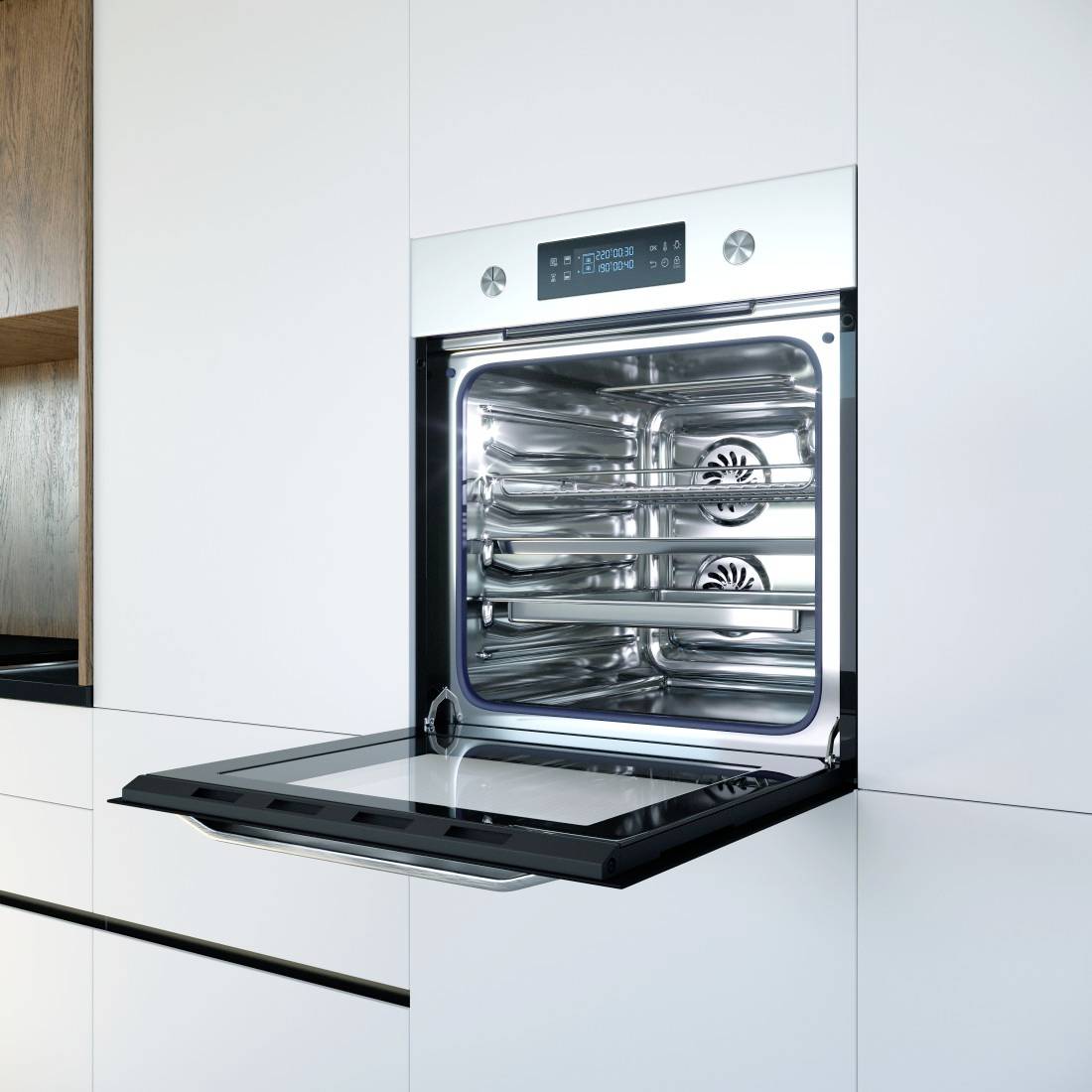 Four brûleur intégré en acier inoxydable avec porte vitrée dans une cuisine blanche moderne, montrant les grilles intérieures et les commandes numériques.
