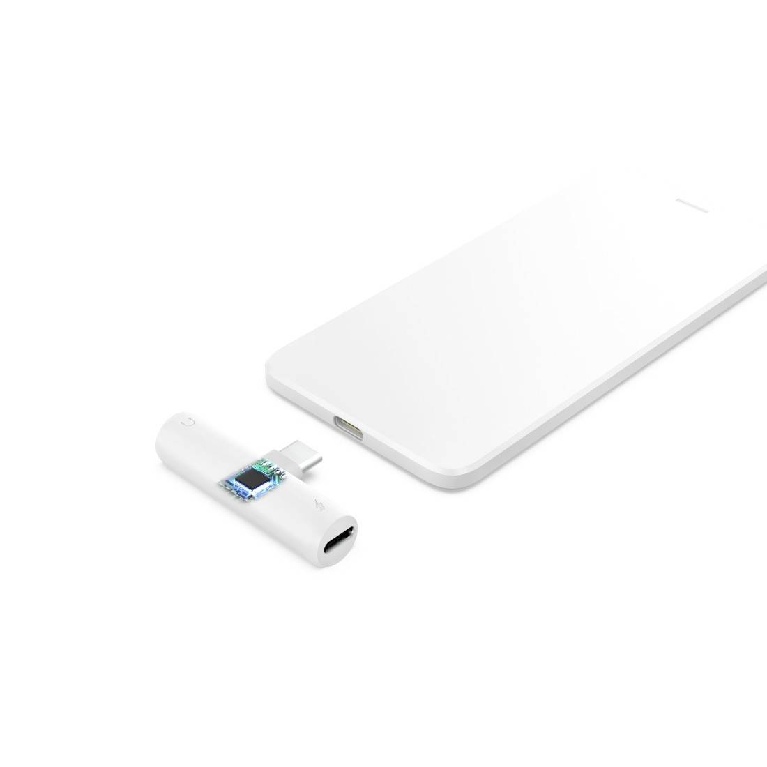 Adaptateur sans fil avec connecteur USB-C à côté d'un appareil blanc et fin, présenté comme accessoire pour la connexion ou la charge.