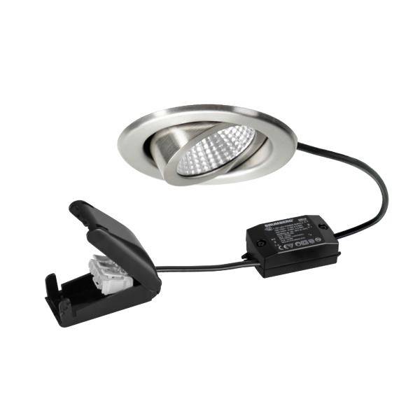 Kit de spot LED encastré avec bague argentée, connecté par câble à un boîtier d'alimentation noir et fixation à ressort sur un fond blanc.