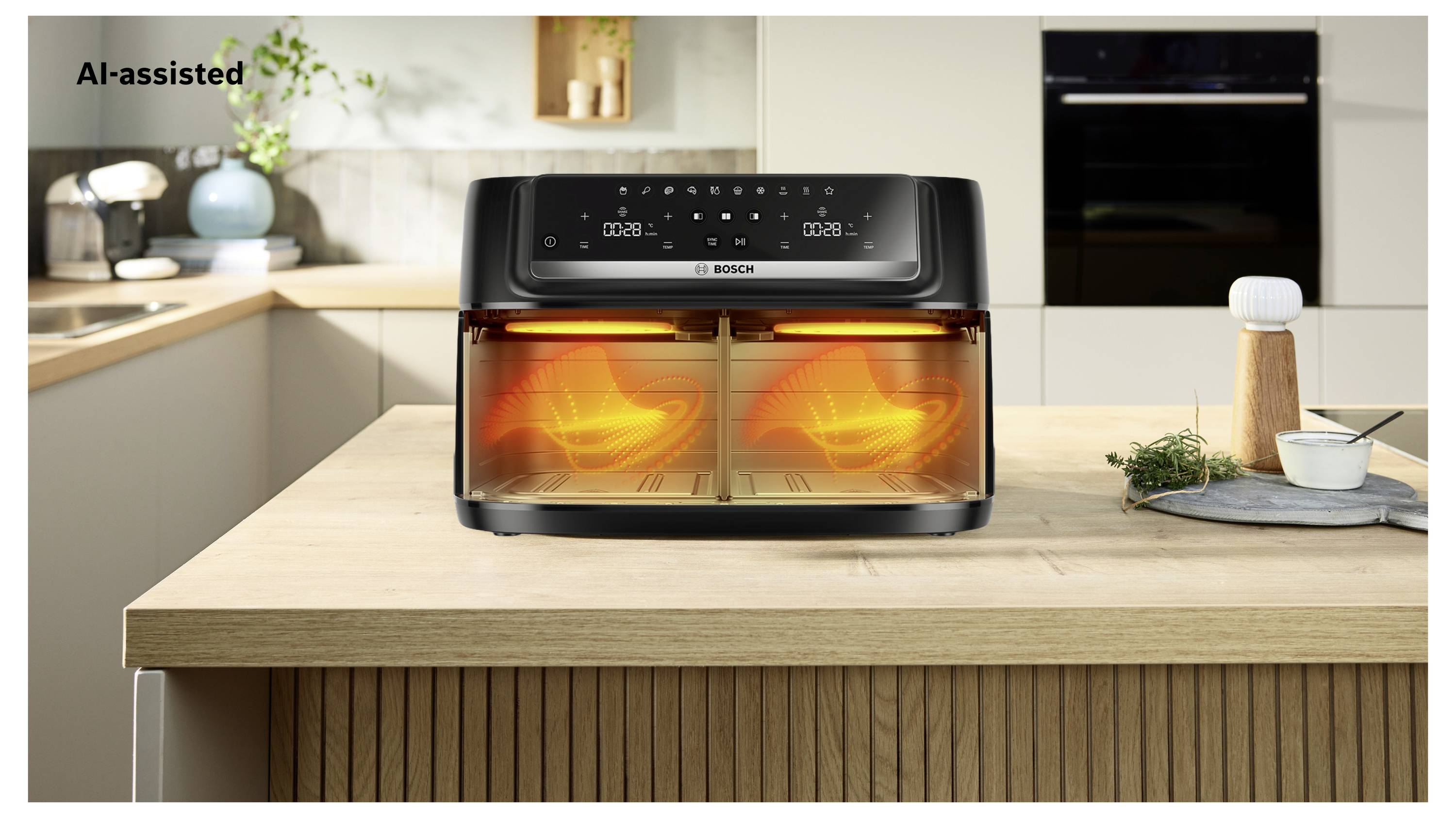 Four à friteuse à air Bosch sur une îlot de cuisine avec deux compartiments de cuisson lumineux, étiqueté « Assisté par l'IA » en haut à gauche.