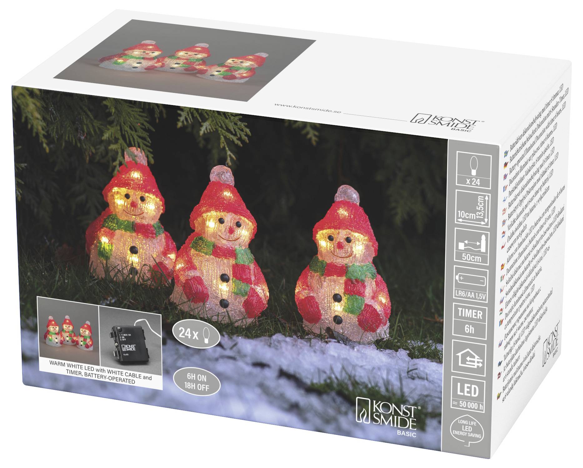 Ensemble de bonhommes de neige LED Konstsmide en boîte avec trois figurines rouges et blanches brillantes dans une scène hivernale enneigée, fonctionnant sur batterie avec minuterie.