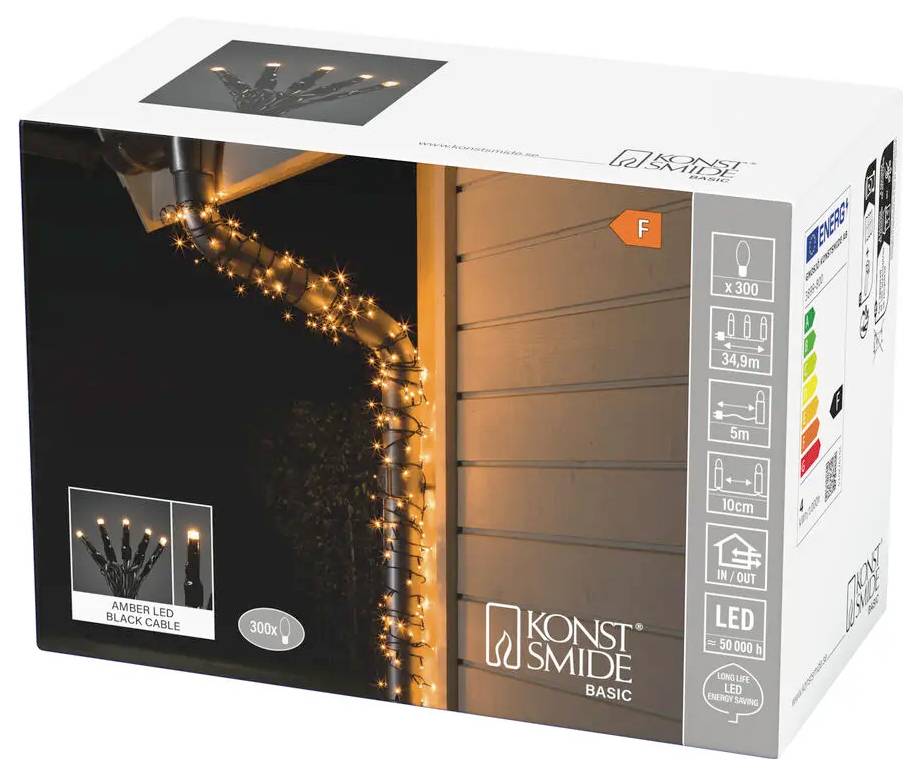 Boîte de produit pour guirlande lumineuse LED ambrée Konstsmide Basic sur câble noir, montrant les lumières allumées enroulées autour d'une gouttière ; l'emballage met en avant 300 DEL et l'utilisation en extérieur.