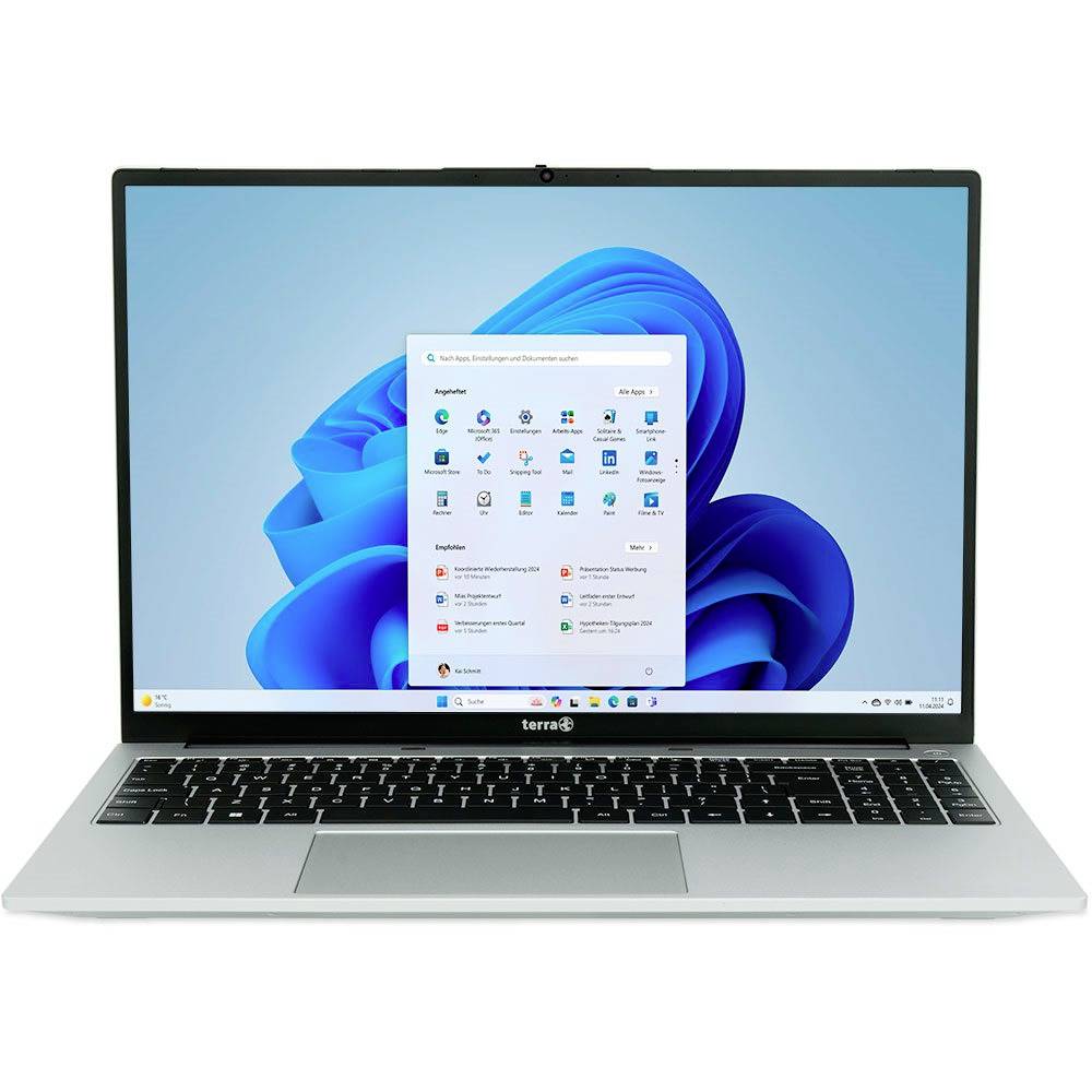 Un ordinateur portable argenté avec Windows 11 affiché à l'écran et le menu Démarrage ouvert sur un fond d'écran bleu abstrait.