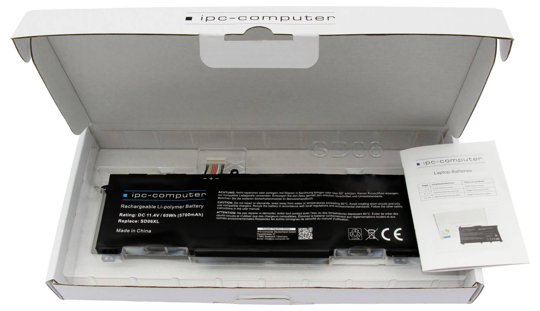 Batterie d'ordinateur portable ouverte dans une boîte d'ordinateur IPC avec une feuille d'instructions imprimée à côté.
