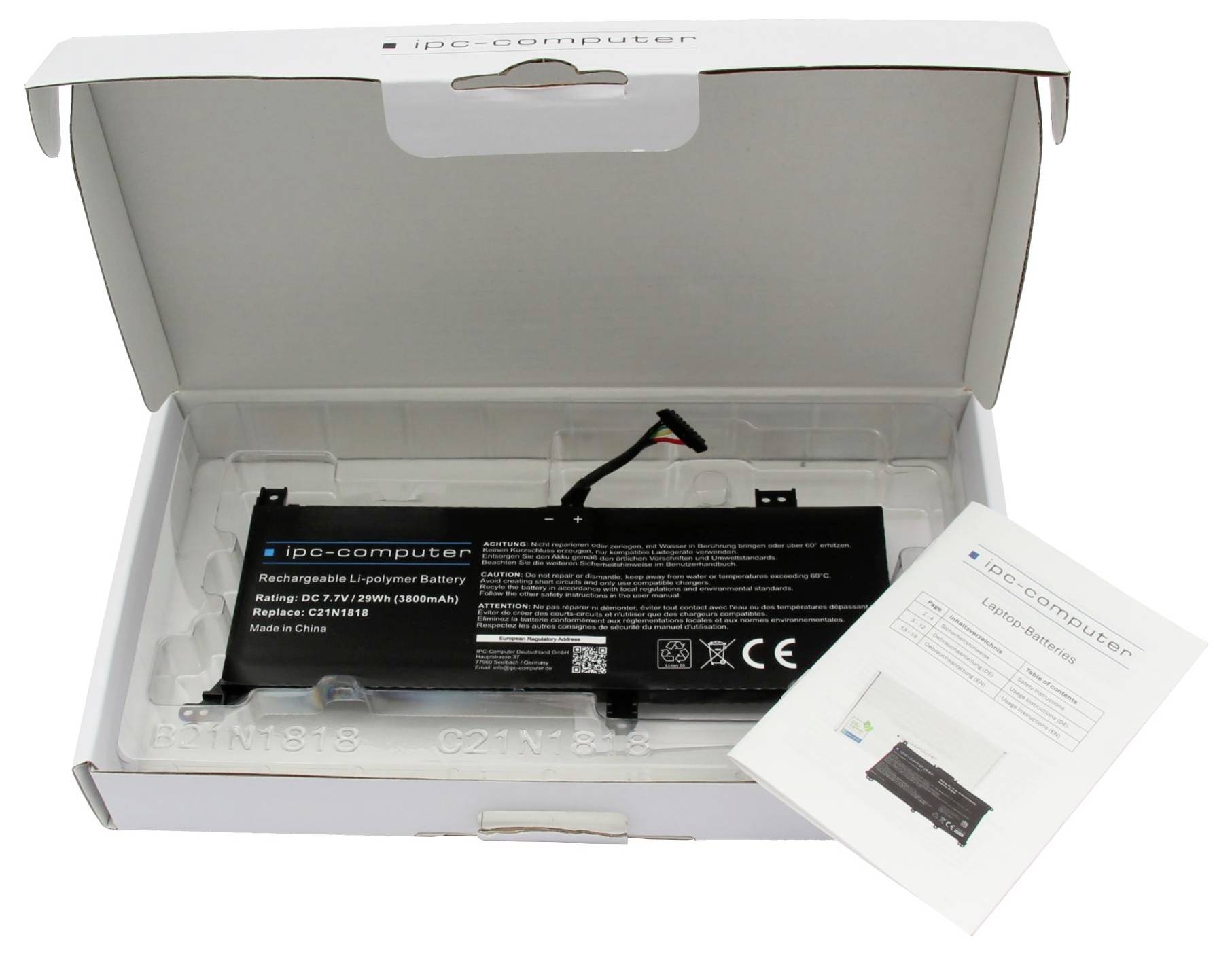 Boîte de batterie pour ordinateur portable ouverte contenant une batterie rechargeable noire avec câble et une notice d'instructions pliée.