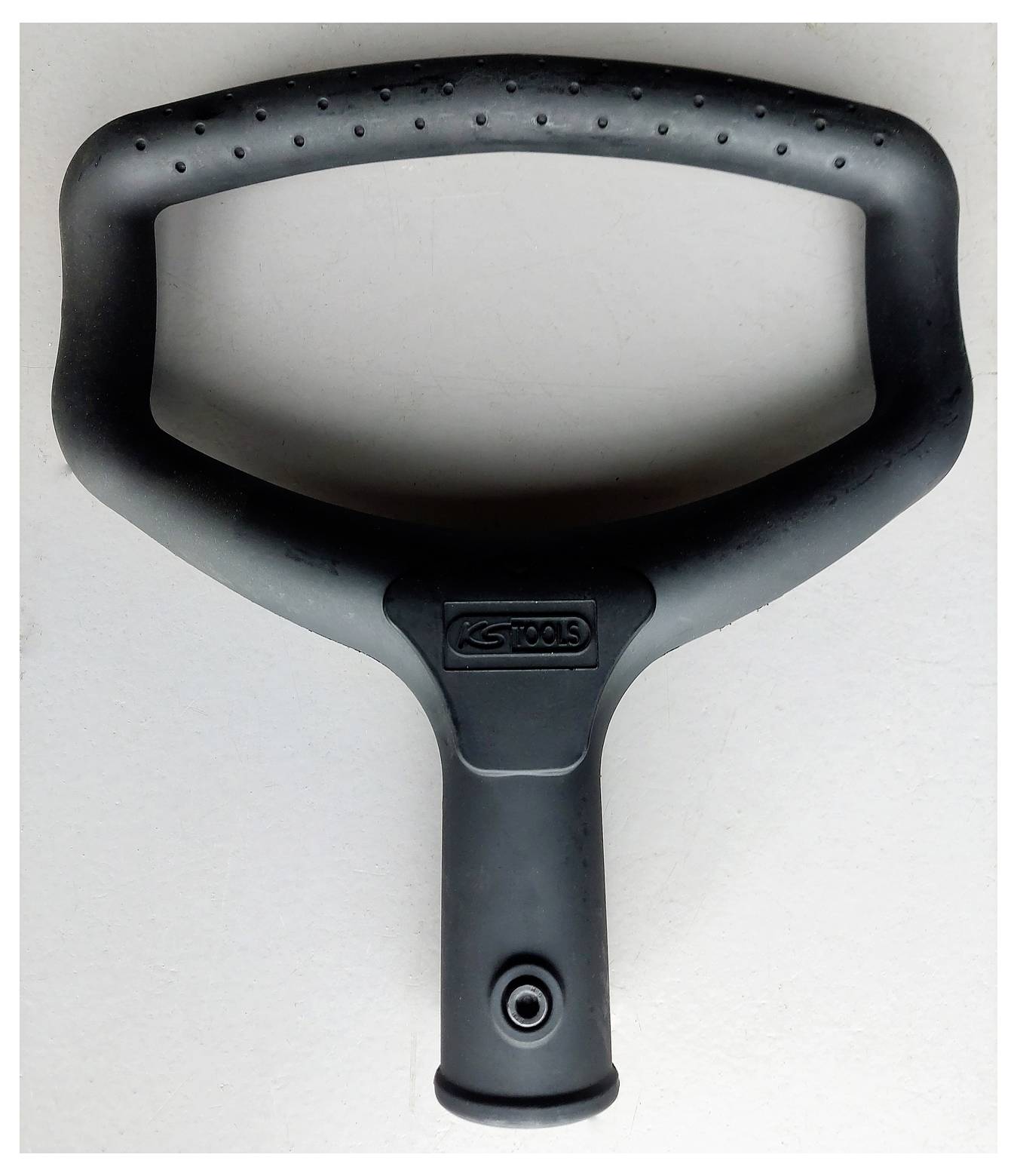 Outil à poignée ou prise ergonomique noire avec un sommet ovale large et le logo « K STools », présenté sur un fond clair uni.