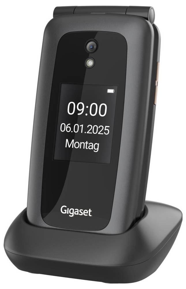 Téléphone à clapet Gigaset noir fermé dans un socle de recharge, affichant l'heure 09:00, la date 06.01.2025 et lundi sur son écran externe.