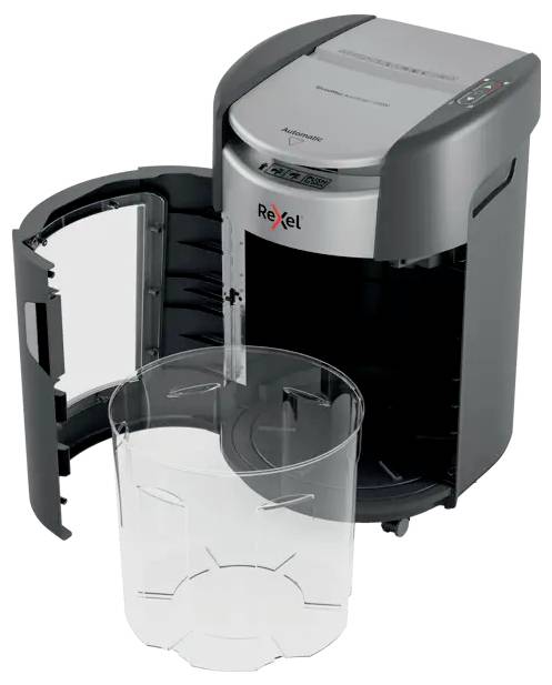 Déchiqueteuse ouverte avec la porte avant ouverte et un bac à déchets transparent tiré vers l'extérieur, montrant le logo Rexel sur la machine.