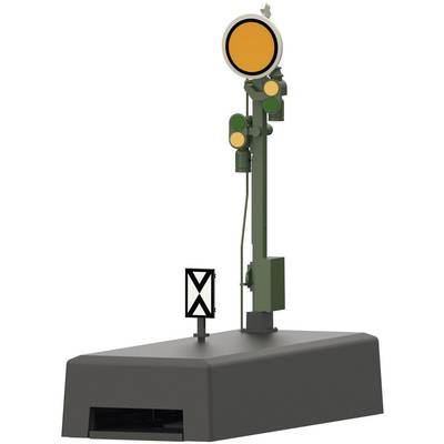 L'image montre un signal ferroviaire avec deux feux verts et deux feux jaunes sur un socle gris.