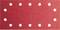 Papier de verre rouge avec 14 trous, disposés de manière rectangulaire.