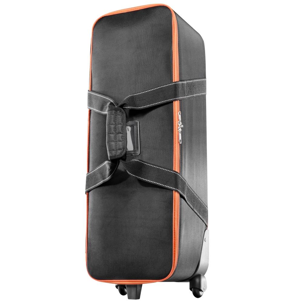 Valise rigide noire avec des touches et des poignées orange, ouverte avec une fermeture éclair et posée sur deux roues.