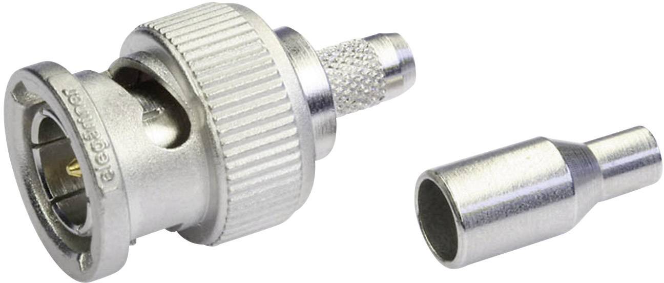 Un connecteur BNC argenté avec une extrémité retirée est posé à côté d'un adaptateur. Utilisé pour les connexions de câbles coaxiaux.