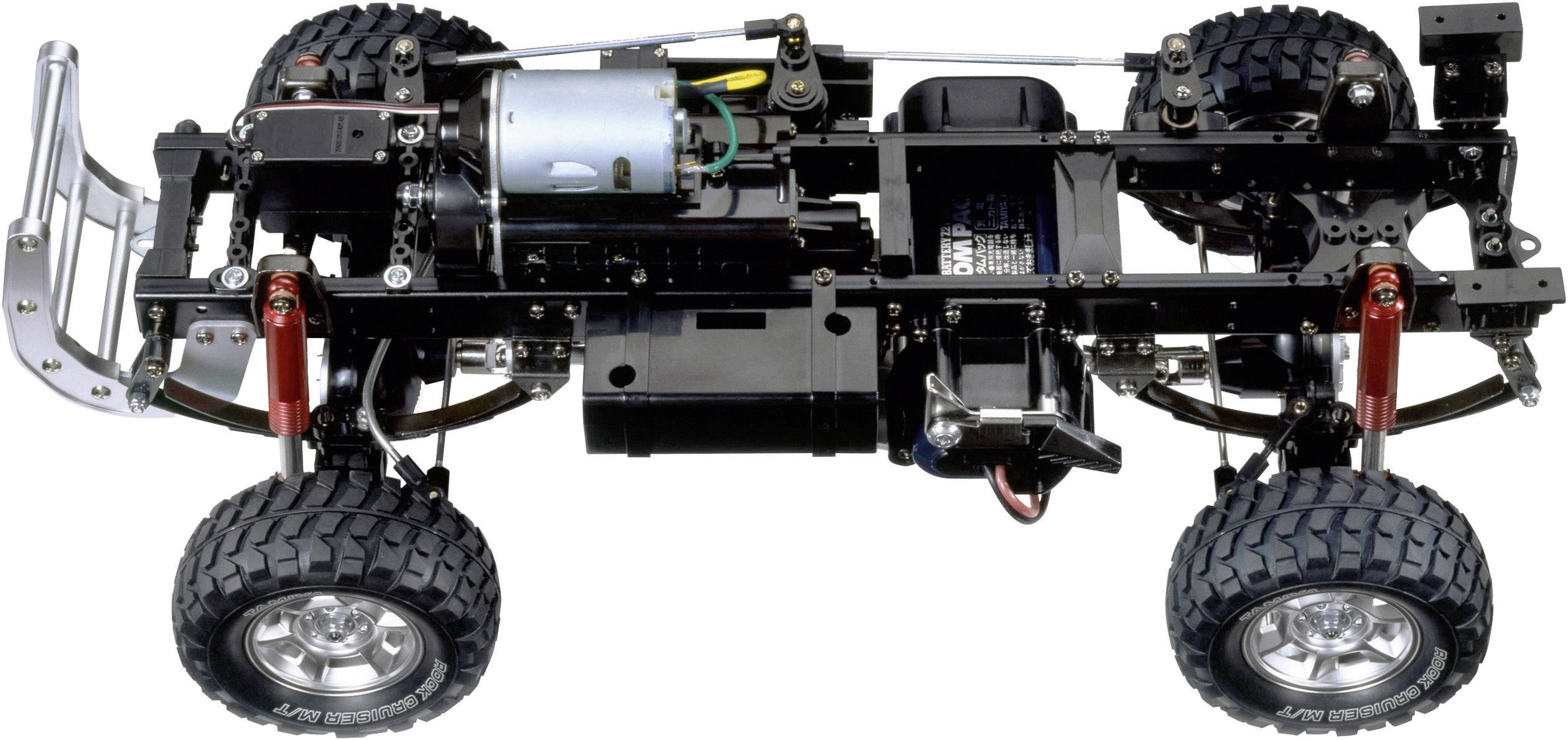 Un châssis de voiture télécommandée à cadre ouvert mettant en valeur le moteur, les essieux et la suspension à ressorts. Idéal pour les passionnés de modélisme.