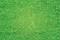 Surface d'herbe verte, pelouse uniforme sans détails ou objets visibles.