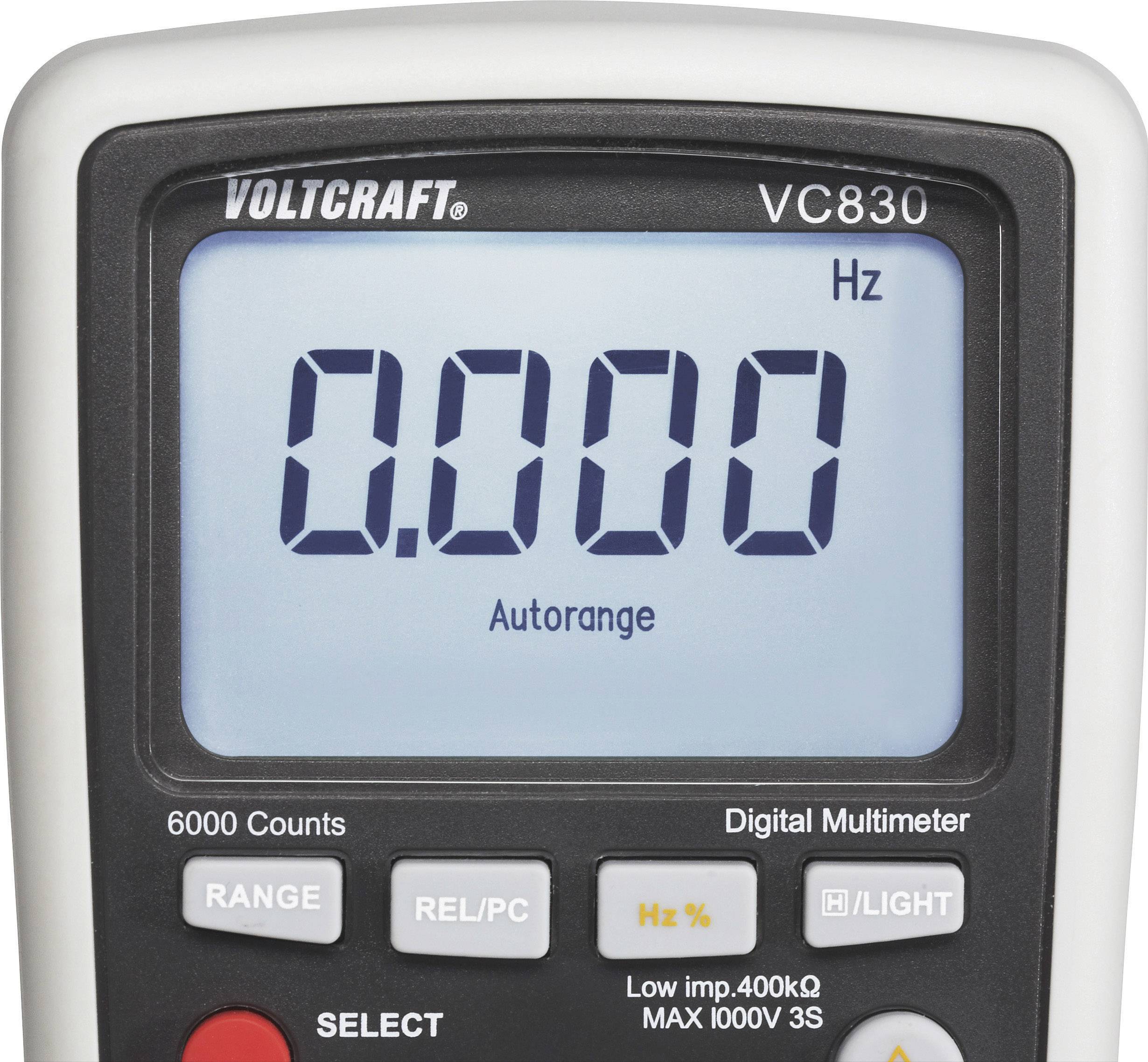 Un multimètre numérique de la marque 'Voltcraft' affiche la valeur '0.000'. L'appareil peut mesurer des tensions jusqu'à 1000 V.