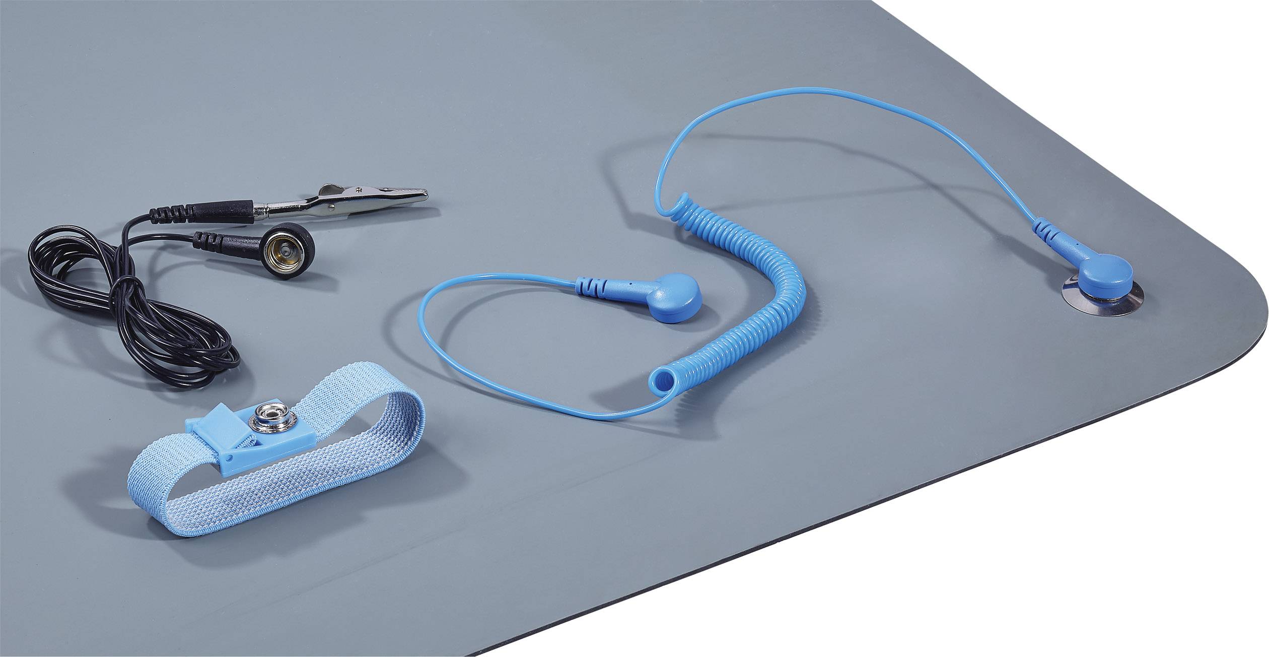 Un tapis antistatique avec pince crocodile, câble de mise à la terre et bracelet de poignet, utilisé pour la protection contre les décharges électrostatiques (ESD) dans les travaux électroniques.