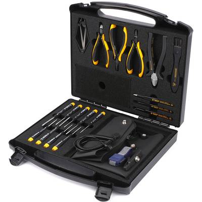 Une boîte à outils ouverte, remplie de divers outils tels que des tournevis, des pinces et des pinces, posée sur de la mousse noire.