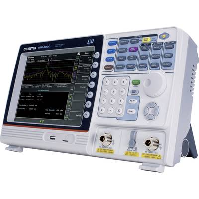 L'image montre un oscilloscope électronique avec un écran couleur sur lequel un graphique est visible. Des boutons et des boutons rotatifs de commande sont disposés à côté.