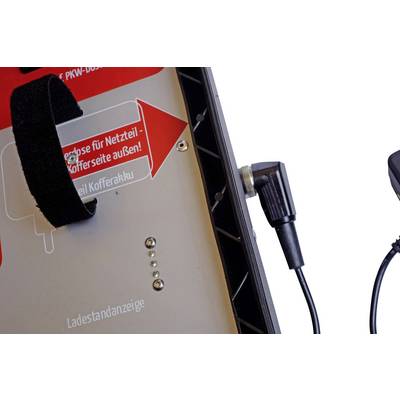Vue latérale d'une station de charge avec entrée d'alimentation et indicateur de charge, une flèche rouge pointe vers la "face extérieure du côté de l'adaptateur".
