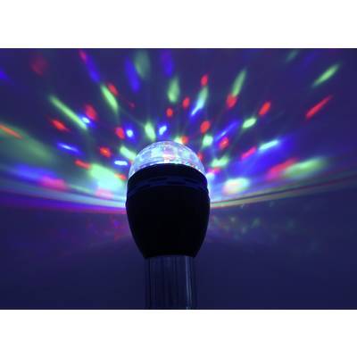 Une lampe noire projette des rayons lumineux colorés en rouge, vert et bleu contre un fond sombre, créant un effet de lumière.