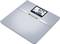 Balance personnelle numérique en argent avec affichage digital. Affiche 62,4 kg et 26% de masse grasse. Marque 'healthcoach', compatible Bluetooth.