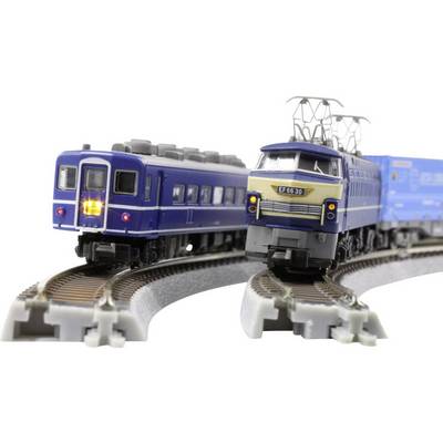 Deux modèles de trains sur des rails ; une locomotive bleue avec une lumière brillante et une autre avec des pantographes, toutes deux en train de parcourir des courbes.